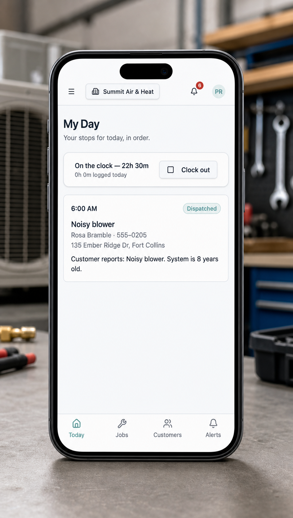 FieldFlow My Day schedule shown on a phone in front of HVAC equipment